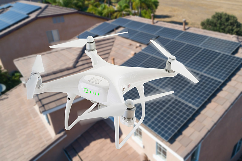 Aerial drone flying over the roof of a house during home inspection services 