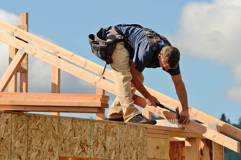 Roofer building a home before home inspection services are scheduled 